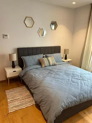 a bedroom with a large bed with two night stands at My Cosy Place Luxury 2BR Apartment CasaFinanceCity in Casablanca