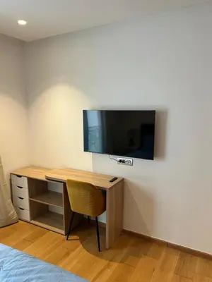 a room with a desk and a tv on a wall at My Cosy Place Luxury 2BR Apartment CasaFinanceCity in Casablanca