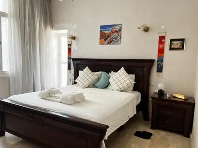 a bedroom with a large bed with towels on it at Lalla Mina Suite with large Terrace - Dar EL BAHIA in Casablanca