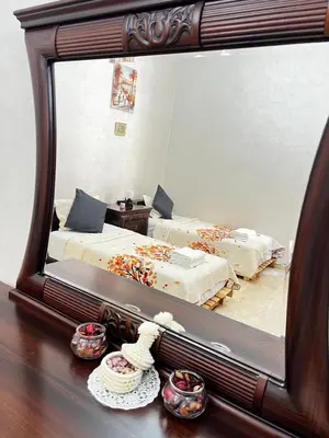 a reflection of a bedroom with two beds in a mirror at Lalla Mina Suite with large Terrace - Dar EL BAHIA in Casablanca