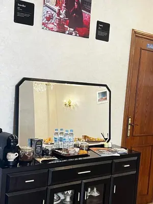a dresser with a large mirror on top of it at Lalla Mina Suite with large Terrace - Dar EL BAHIA in Casablanca