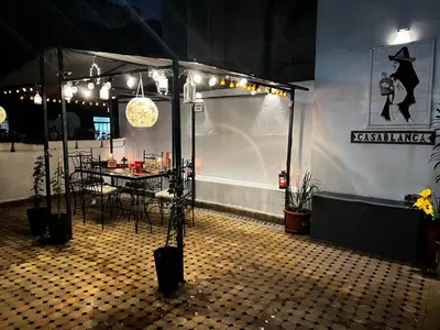 a tent with a table and chairs in a room at Lalla Mina Suite with large Terrace - Dar EL BAHIA in Casablanca