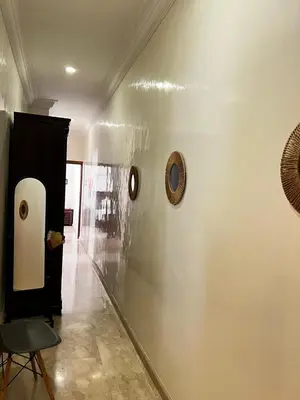 a hallway with two pictures on the wall and a chair at Lalla Mina Suite with large Terrace - Dar EL BAHIA in Casablanca