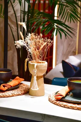 a table with a vase with dried plants in it at Le Sublime in Casablanca