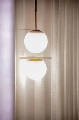 a light hanging from a wall next to a curtain at Le Sublime in Casablanca