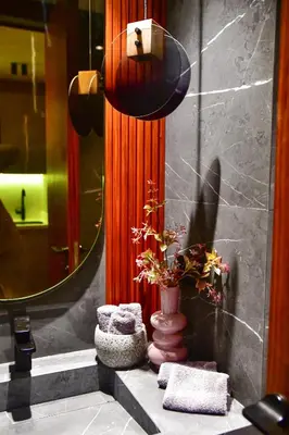 a bathroom with a mirror and a vase with a plant at Le Sublime in Casablanca