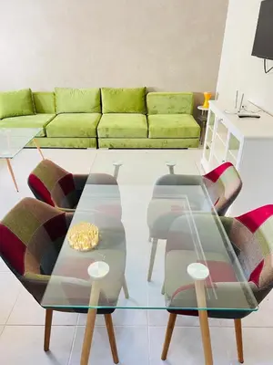 a living room with a couch and a glass table at Fal azure in Bouznika