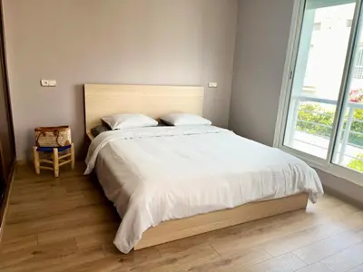 a bedroom with a large bed and a window at Charming villa in a coastal area in Casablanca