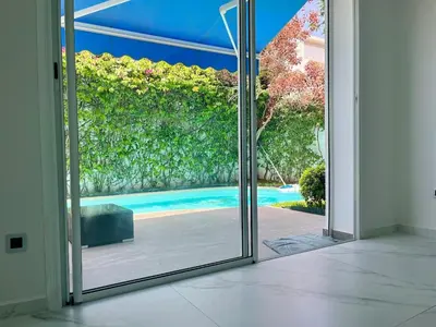 an open glass door with a view of a swimming pool at Charming villa in a coastal area in Casablanca