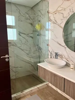 a bathroom with a sink and a glass shower at Charming villa in a coastal area in Casablanca