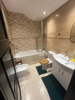 a bathroom with a sink and a toilet and a tub at Garden beach 2 in Sidi Rahal