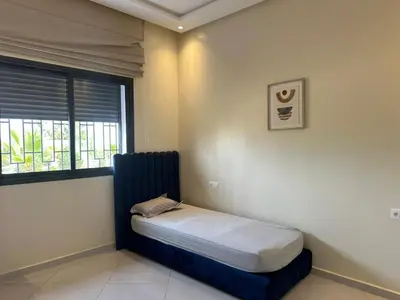 a small bed in a room with a window at la ferme du bonheur in Aïn el Apuda