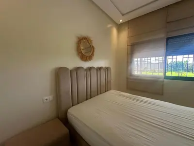 a bedroom with a bed and a window at la ferme du bonheur in Aïn el Apuda