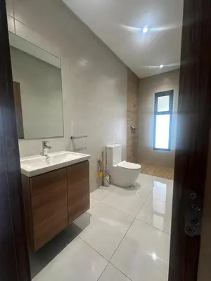 a bathroom with a sink and a tub and a toilet at la ferme du bonheur in Aïn el Apuda