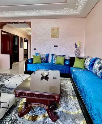 a living room with two blue couches and a coffee table at Superbe T3 ensoleillé avec Terrasse - 2 chambres - Casablanca in Casablanca