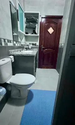 a bathroom with a toilet and a sink and a door at Superbe T3 ensoleillé avec Terrasse - 2 chambres - Casablanca in Casablanca