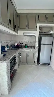 a kitchen with a stainless steel refrigerator and cabinets at Superbe T3 ensoleillé avec Terrasse - 2 chambres - Casablanca in Casablanca