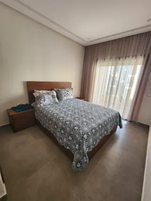 a bedroom with a bed and a window at Apparemment de détente in Mansouria