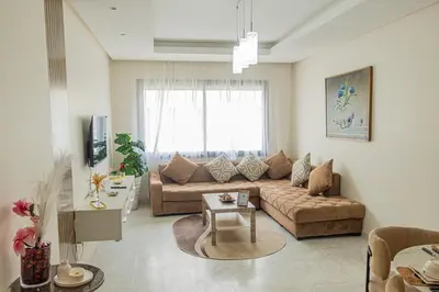 a living room with a couch and a table at VIVASTAY Casablanca - Charming Studio Nouacer - 4 min Airport Mohamed V CMN in Nouaseur