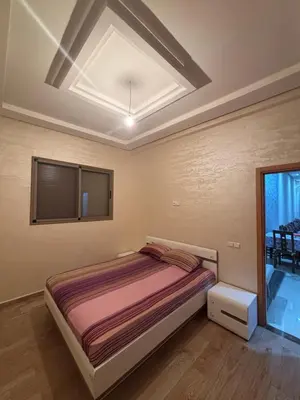 a bedroom with a bed and a skylight at Mandarona in Bouznika