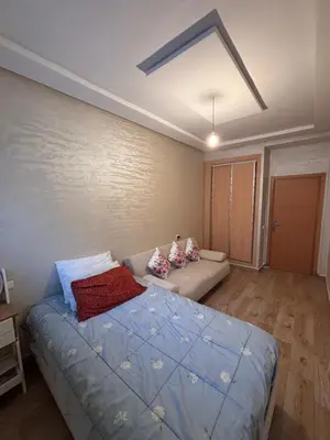 a bedroom with a bed and a couch at Mandarona in Bouznika