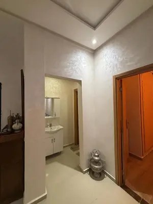 a room with a kitchen with a sink and a mirror at Mandarona in Bouznika