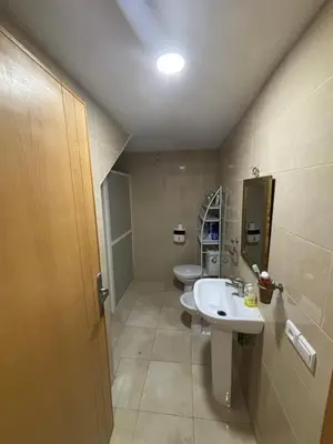 a bathroom with two sinks and two toilets at Mandarona in Bouznika