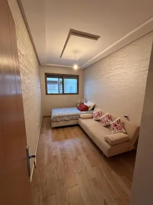 a room with a couch and a bed in it at Mandarona in Bouznika
