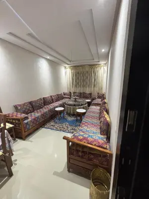 a living room with a couch and a table at Mandarona in Bouznika