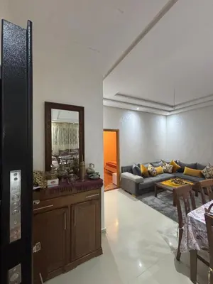a living room with a couch and a mirror at Mandarona in Bouznika