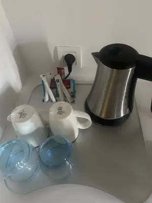 a counter top with a coffee pot and measuring cups at chic & cozy Apartment, Parc Serenity in Mohammedia