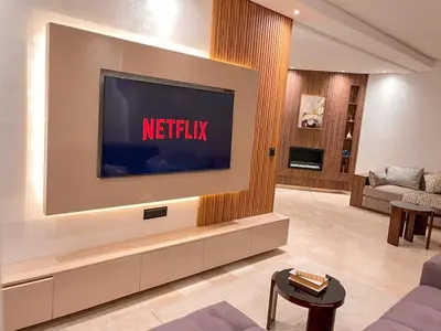 a living room with a television on a wall at Chic, well-equipped apartment in a perfect location in Temara