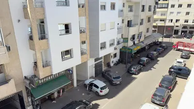 a view of a street with cars parked in front of buildings at Charming City Retreat in Agdal - Walk to Train Station in Rabat