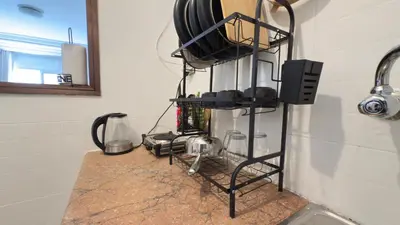 a kitchen counter with pots and pans on a shelf at Charming City Retreat in Agdal - Walk to Train Station in Rabat