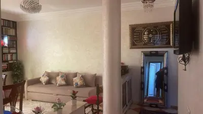 a living room with a couch and a mirror at Summer sale two bedroom APT Near downtown in Casablanca