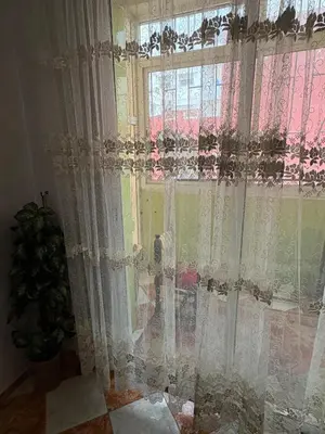 a window with lace curtains in a room at Summer sale two bedroom APT Near downtown in Casablanca