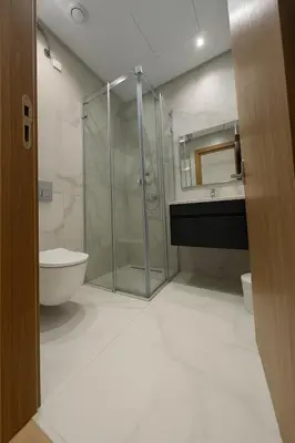 a bathroom with a shower and a toilet and a sink at Petit bijou à Hay Riad in Rabat