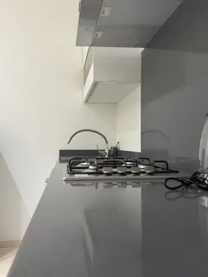 a stove top oven in a kitchen with at Petit bijou à Hay Riad in Rabat