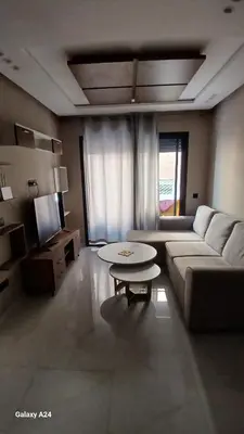 a living room with a couch and a table at Bsmilah in Rabat