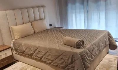 a bedroom with a large bed with a pillow on it at Bsmilah in Rabat