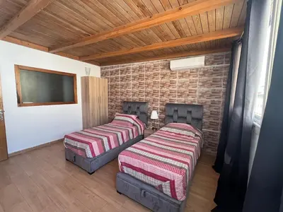 a room with two beds and a flat screen tv at Superbe appartement à l'Agdal in Rabat