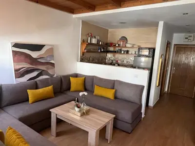 a living room with a couch and a table at Superbe appartement à l'Agdal in Rabat