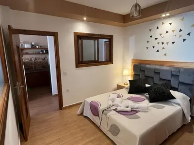 a bedroom with a large bed and a mirror at Superbe appartement à l'Agdal in Rabat