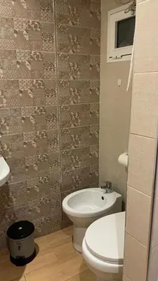 a bathroom with a white toilet and a sink at Superbe appartement à l'Agdal in Rabat