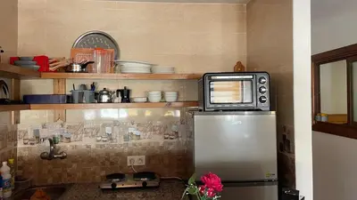 a microwave sitting on top of a refrigerator in a kitchen at Superbe appartement à l'Agdal in Rabat