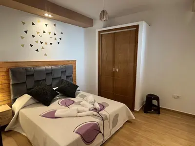 a bedroom with a bed with a stuffed animal on it at Superbe appartement à l'Agdal in Rabat