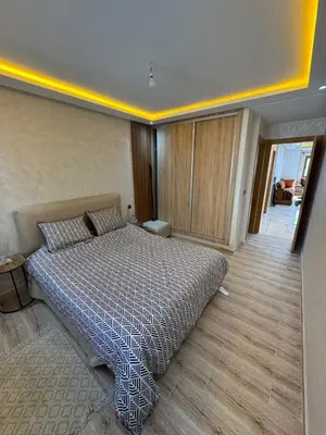 a bedroom with a large bed in a room at Appartement à Dahomey - Bouznika in Bouznika