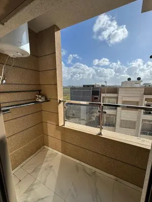 a balcony with a large window with a view at Appartement à Dahomey - Bouznika in Bouznika