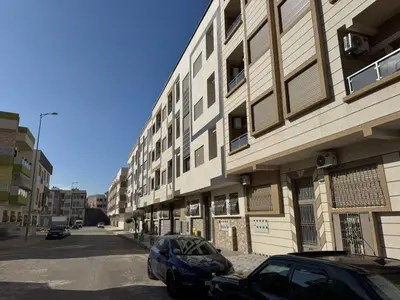 a car parked on a street next to a building at Appartement à Dahomey - Bouznika in Bouznika