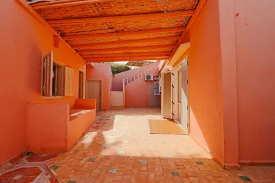 an empty hallway of an orange building with a wooden ceiling at Casa Nova Maison moderne à deux pas de la plage in Bouznika